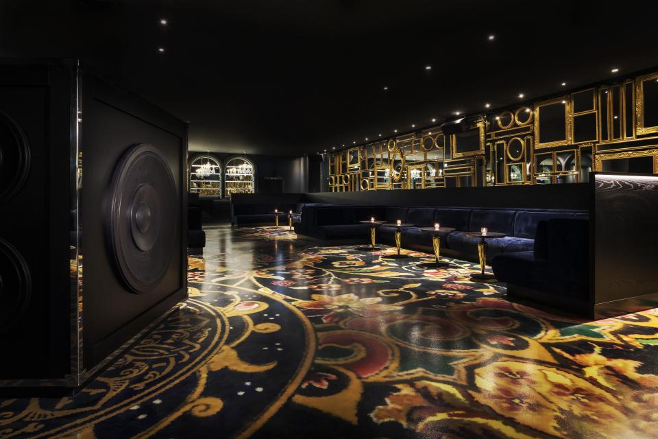 Luxurious bar interior of Mondrian Doha hotel featuring elegant seating and ornate patterned flooring by Marcel Wanders.