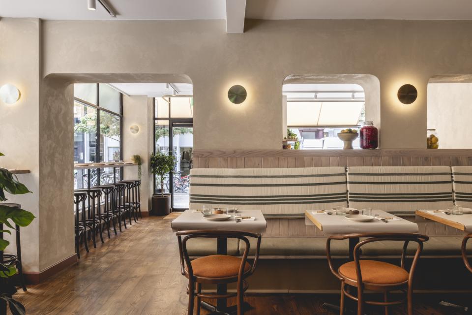 Warm and inviting interior of Honey & Co in Bloomsbury, showcasing modern design and cozy dining space.