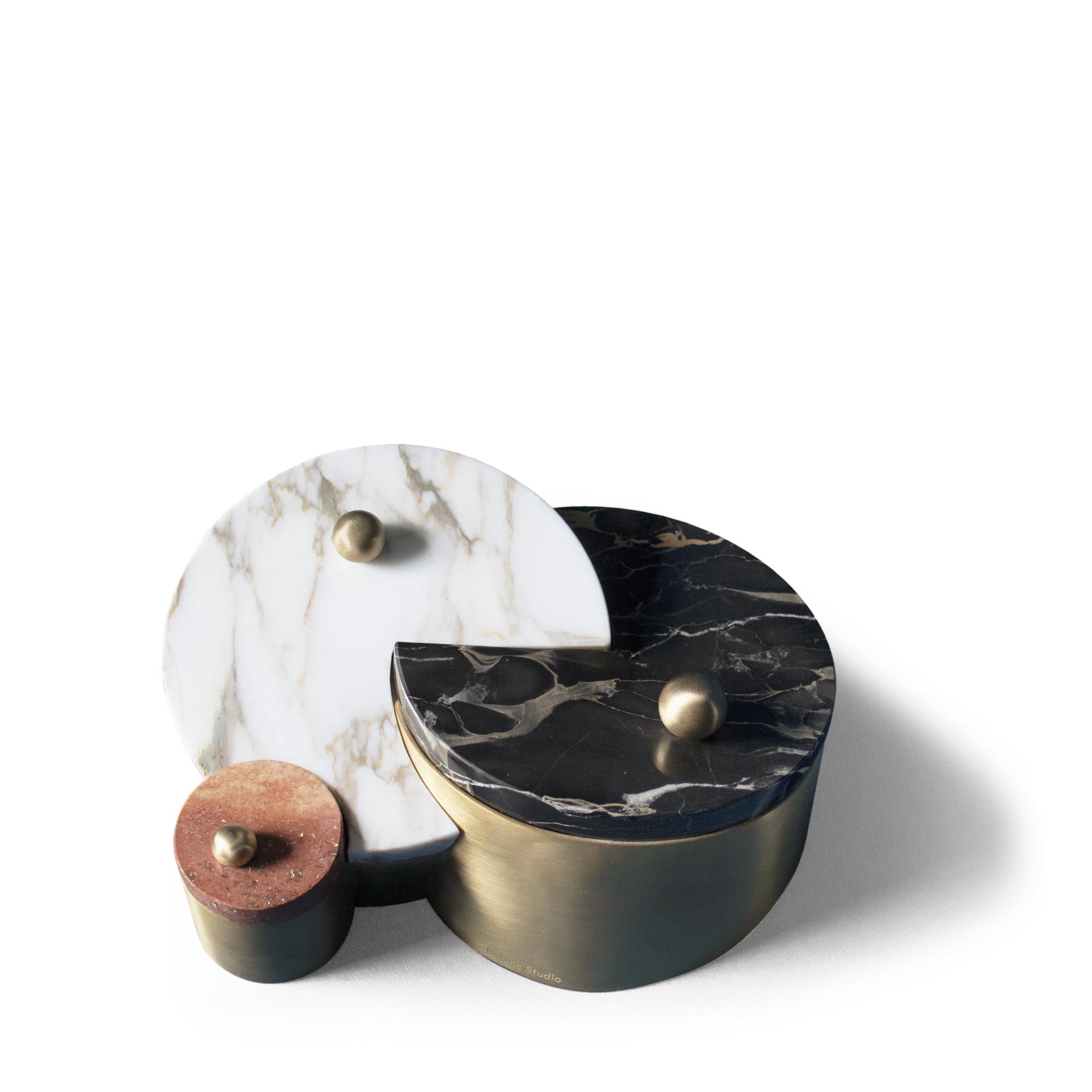 Elegant sculptural objects featuring marble and brass elements, showcasing Lara Bohinc's innovative furniture design approach.