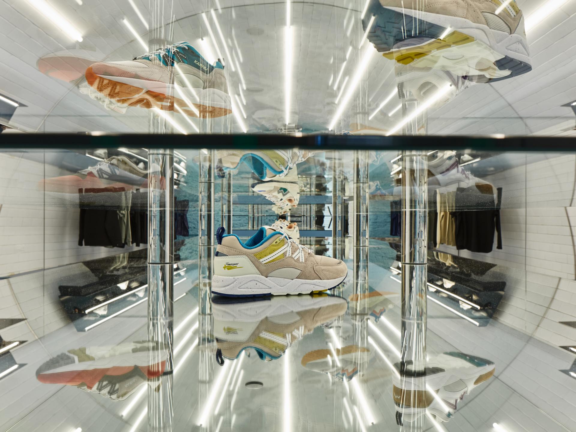 Stylish sneakers displayed on a reflective surface in the modern COEF clothing shop in Utrecht.