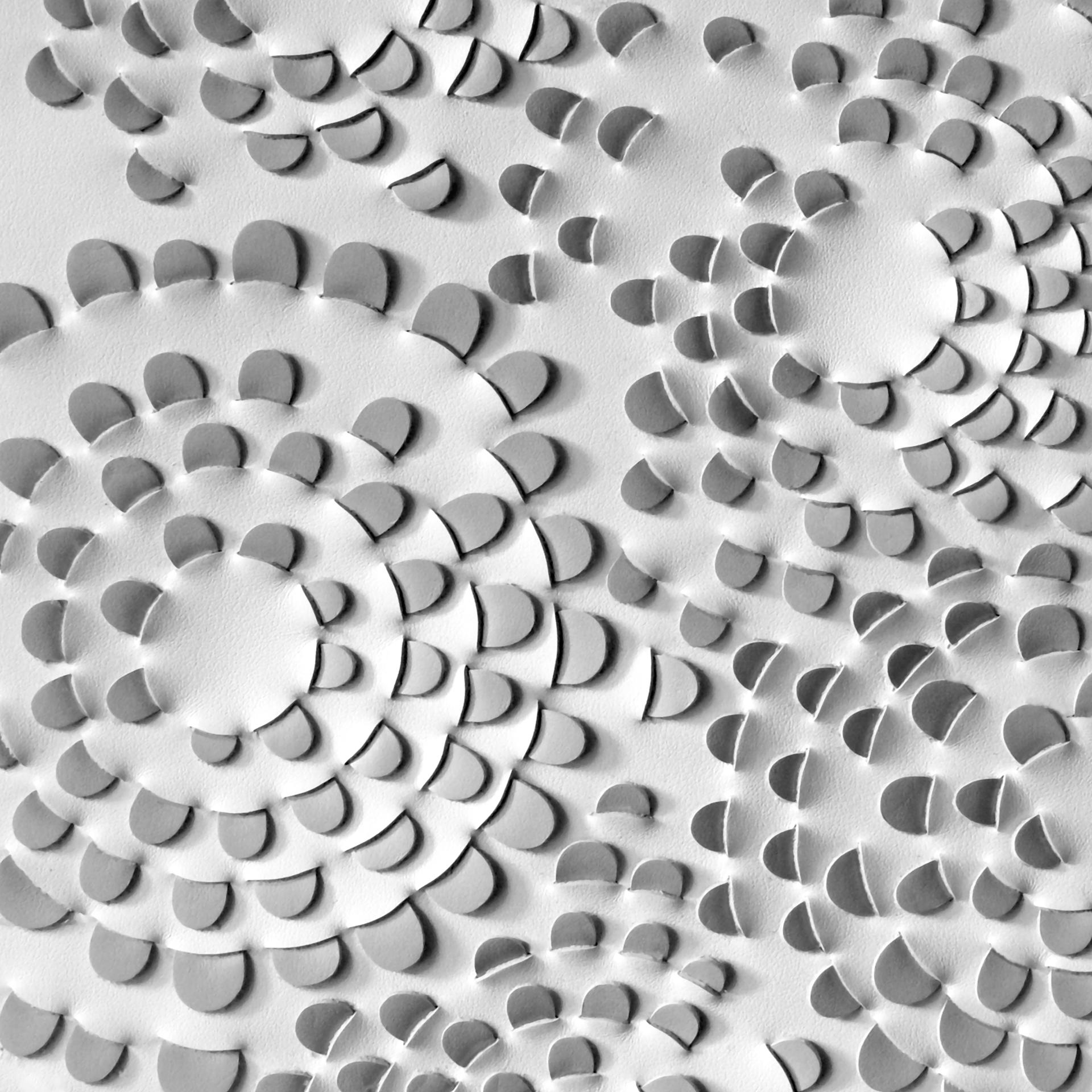 Textured paper art featuring intricate layered designs, showcasing craftsmanship and material innovation by Louisa Pacifico of Future Icons.