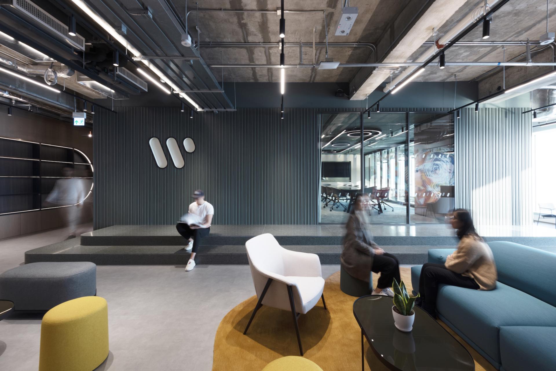 Modern office space designed by Bean Buro for Warner Music Hong Kong, featuring stylish seating and collaborative areas.