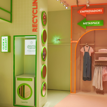 Bright citrus-themed interior of the Mango Teen store in Barcelona, featuring recycling and collection signage.