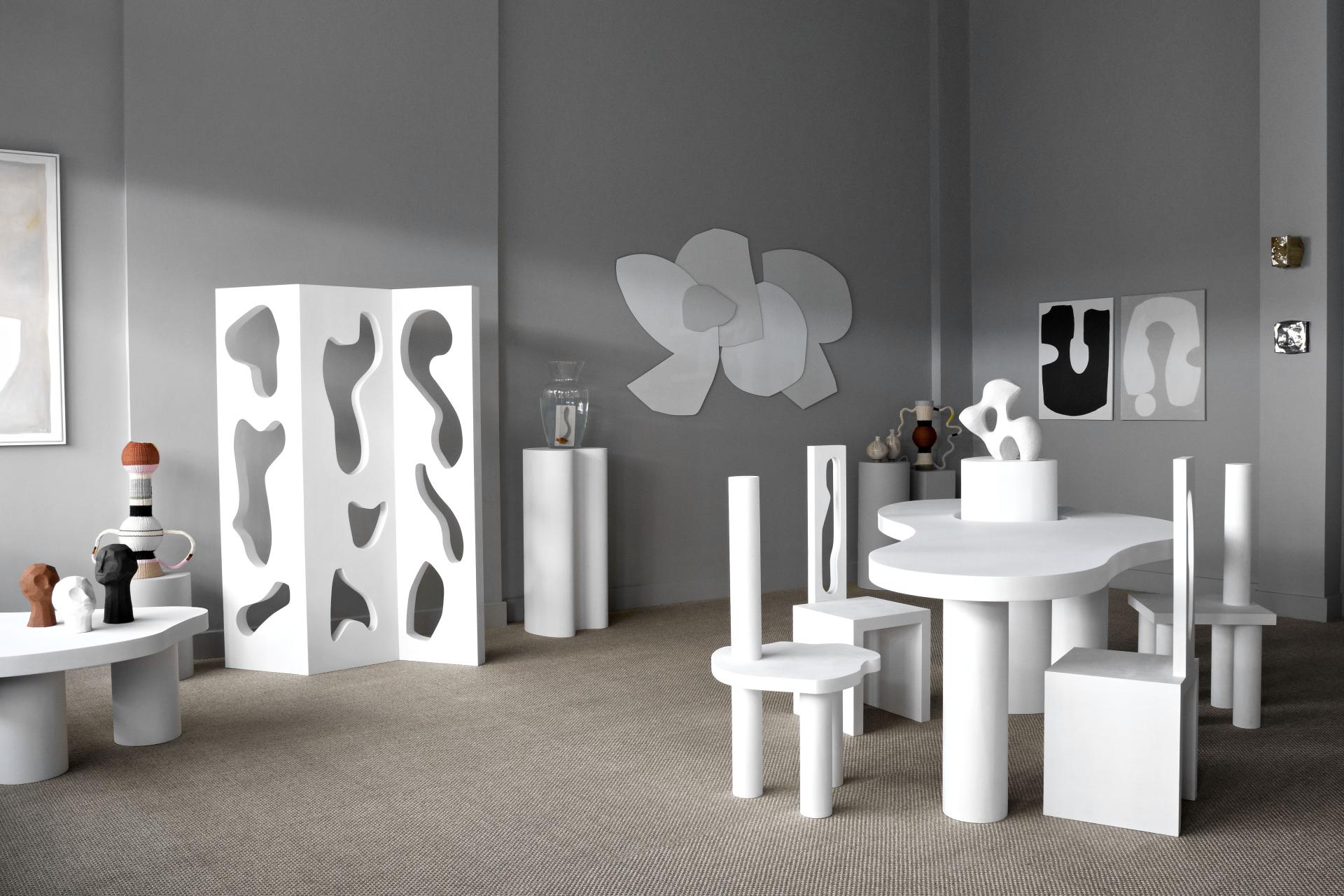 Modern art furniture display featuring unique white prototypes and abstract sculptures during the London Design Festival.