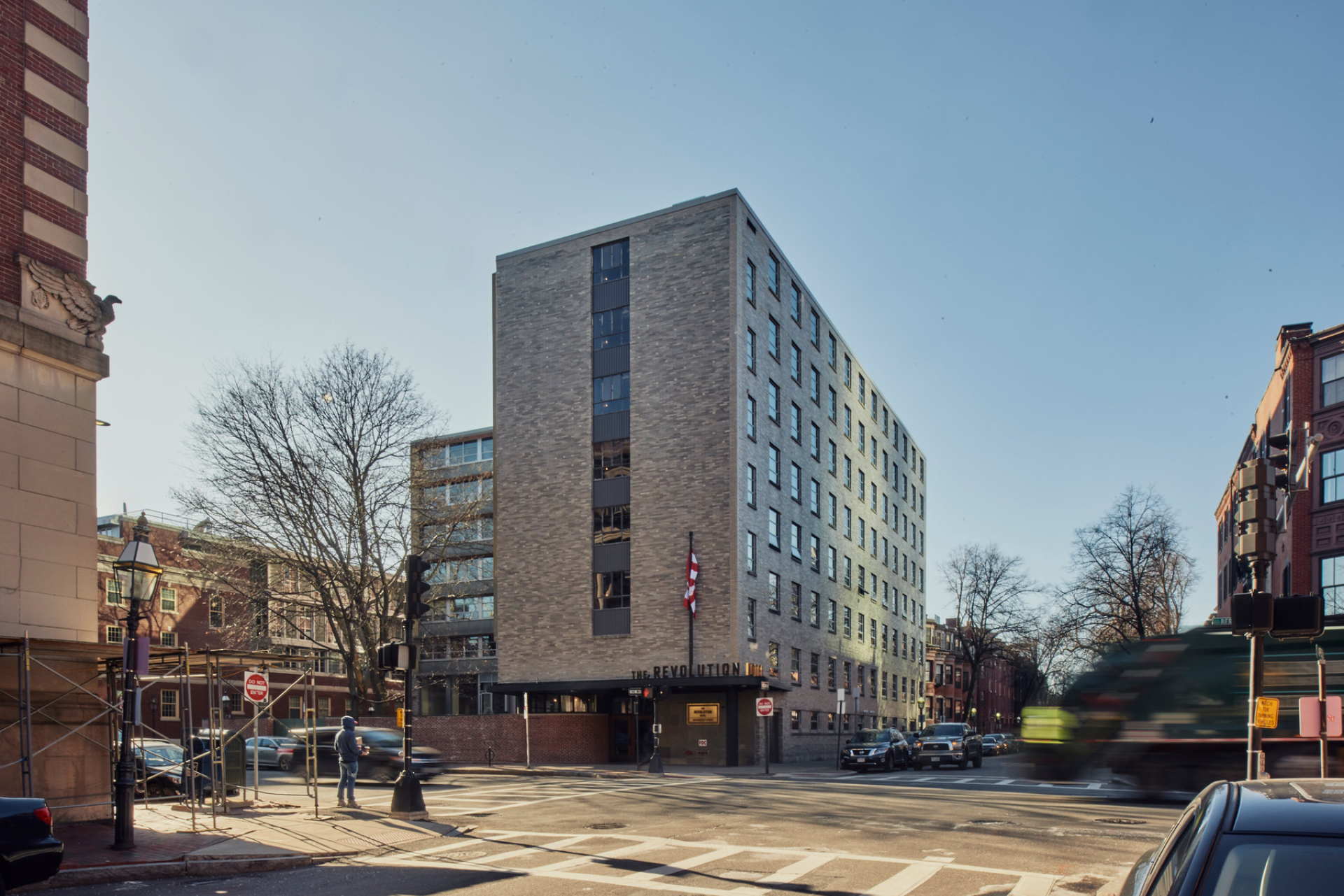 The Revolution Hotel in Boston, featuring modern architecture and a historic neighborhood backdrop, embodies local heritage design.