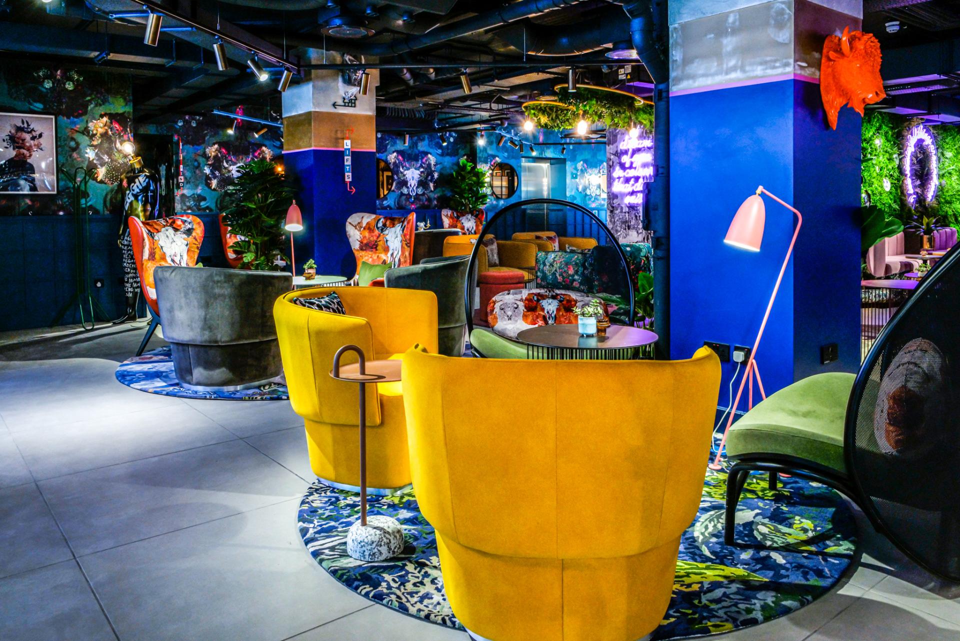 Vibrant lounge area featuring bold furniture and artistic decor at Manchester's Qbic hotel by BOBO1325.