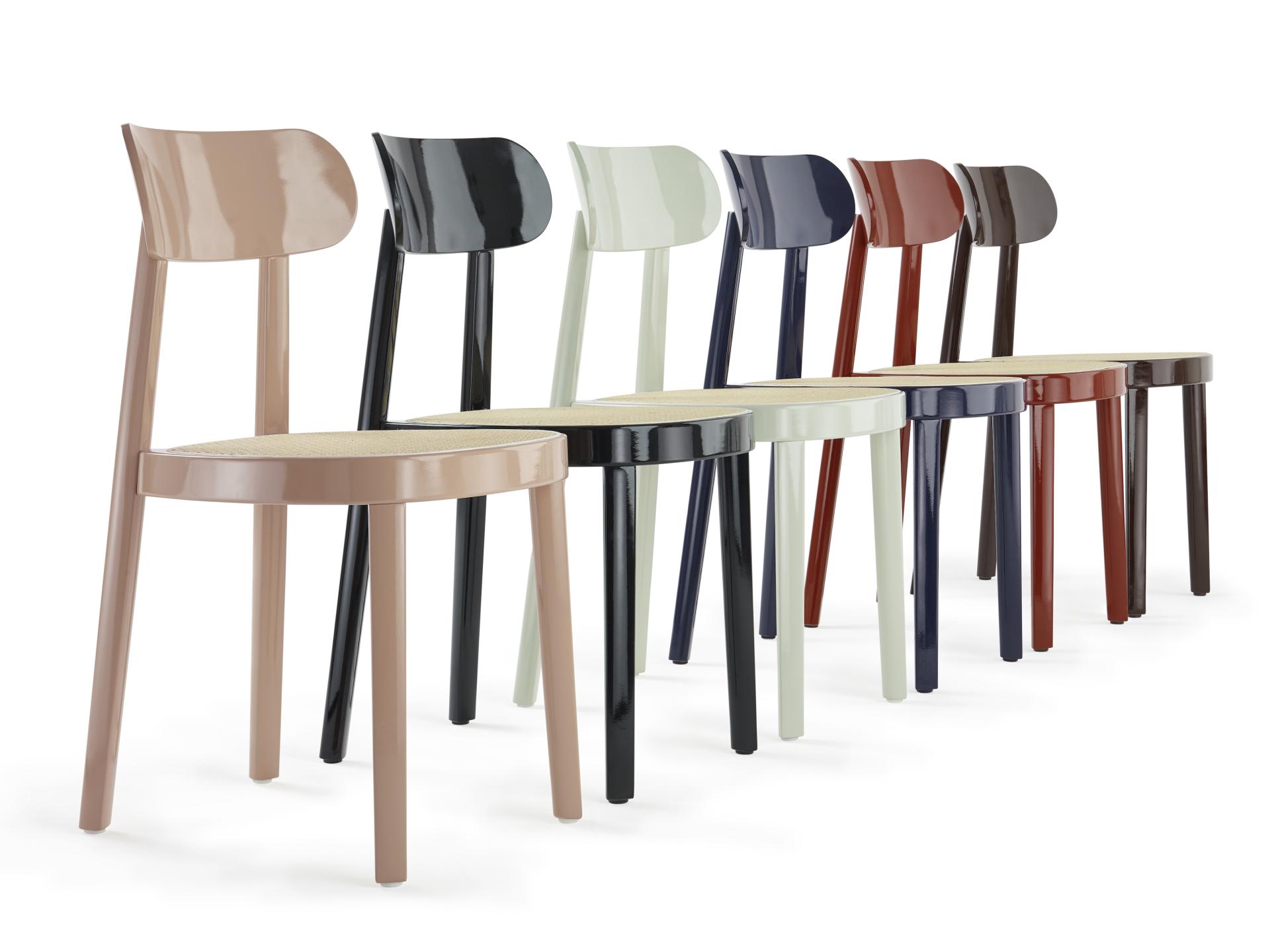 Colorful modern chairs designed by Thonet, showcasing unique shapes and Bauhaus-inspired aesthetics for a centennial celebration.