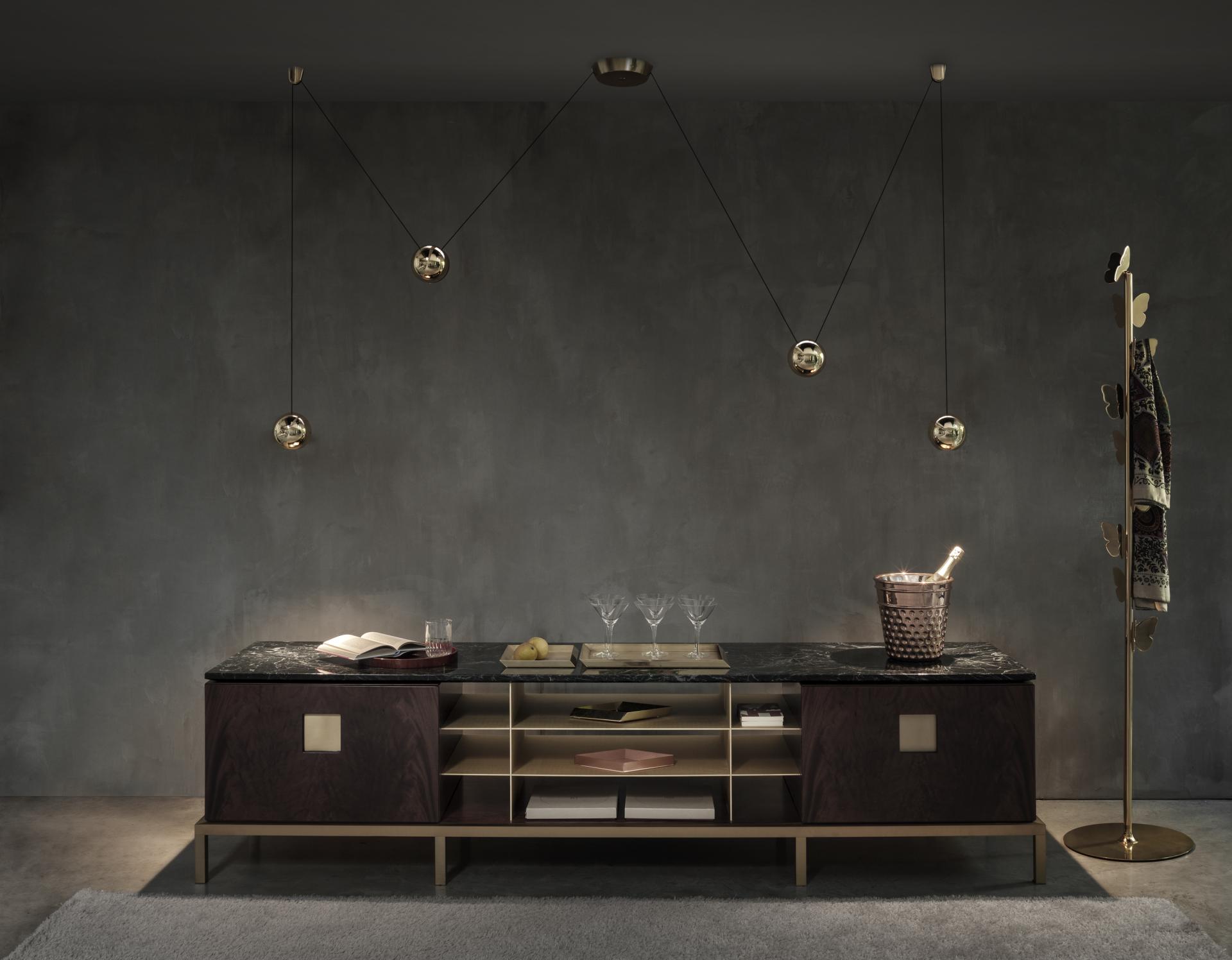 Modern GHIDINI 1961 brass furniture featuring a marble-top cabinet and stylish pendant lighting in a sophisticated interior setting.