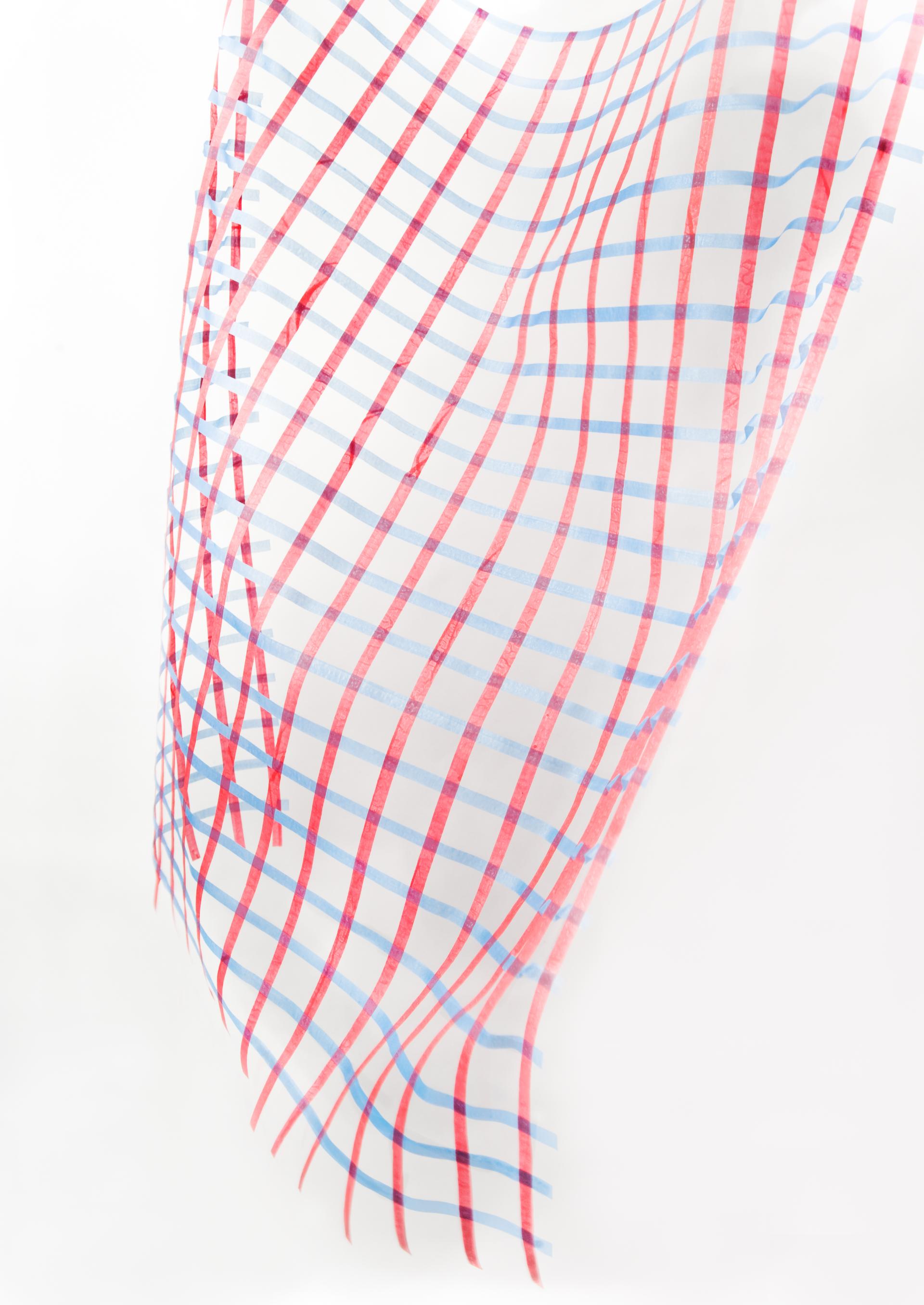 Translucent fabric featuring a grid pattern in red and blue, highlighting design innovation with recycled plastic.