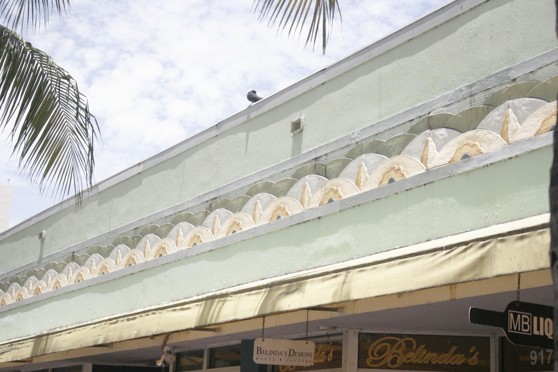 Historic architecture featuring a pastel green facade and decorative elements, typical of northern seaside towns revival.