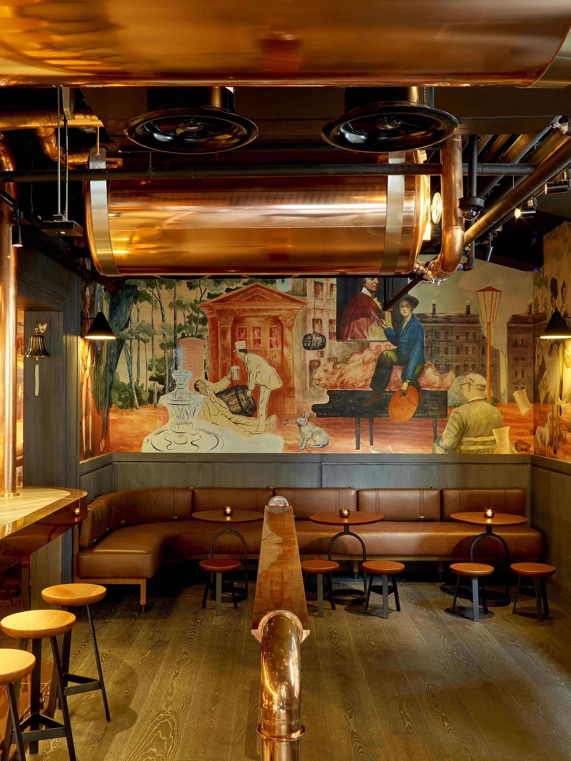 Theatrical interior of Leicester Square hotel bar featuring copper accents and mural artwork, creating an otherworldly atmosphere.