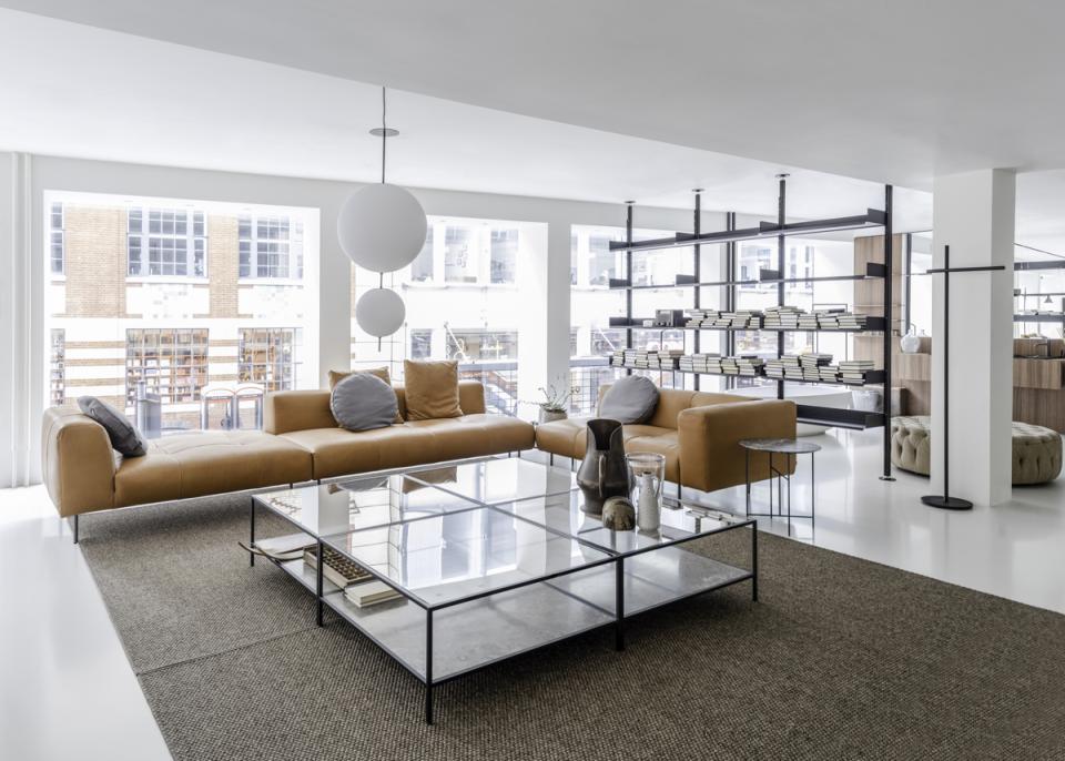 Spacious interior of De Padova's new London flagship store featuring a modern lounge area with innovative furniture and decor.