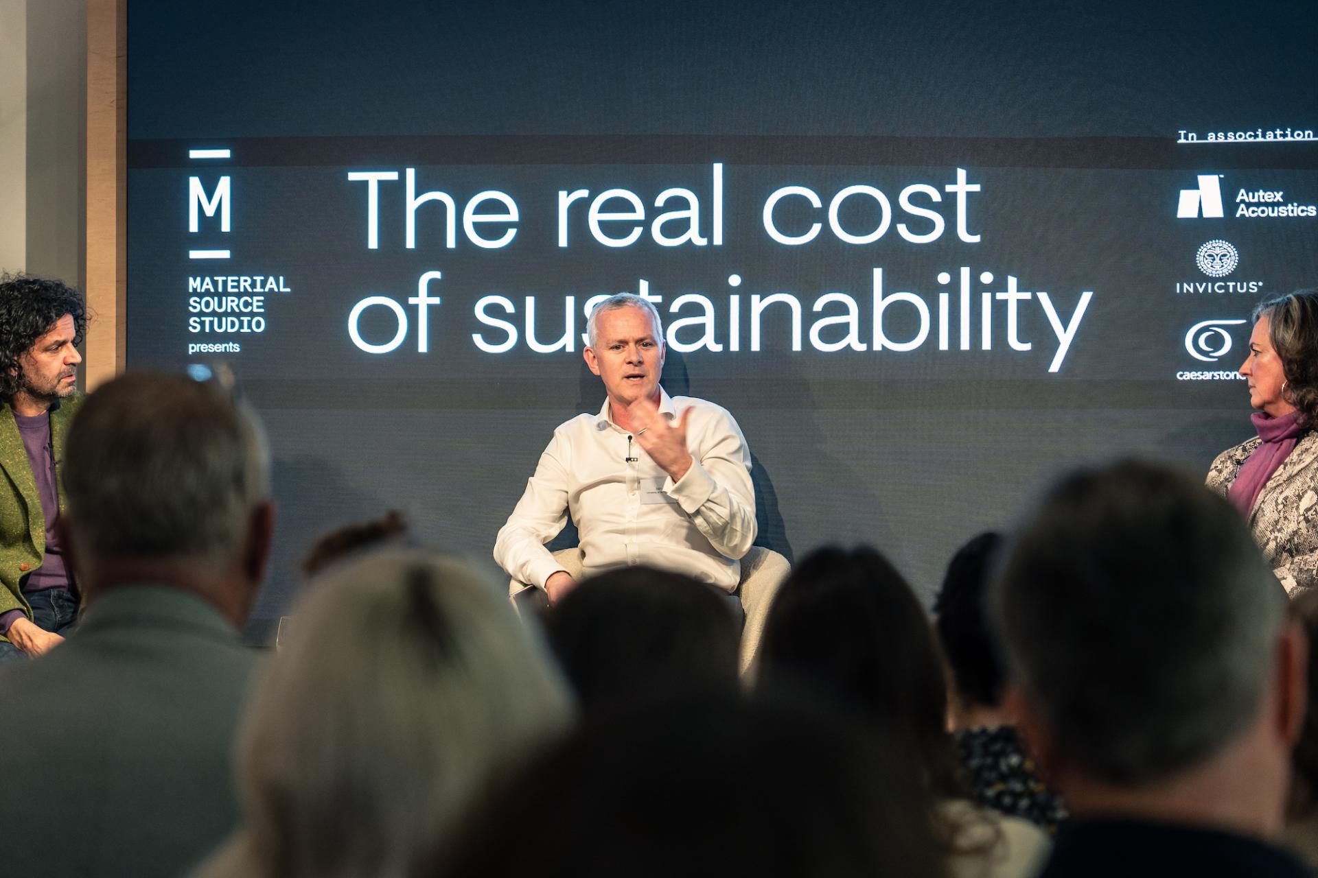 Panel discussion at Material Source Studio Glasgow on the real cost of sustainability, featuring engaged speakers and an attentive audience.