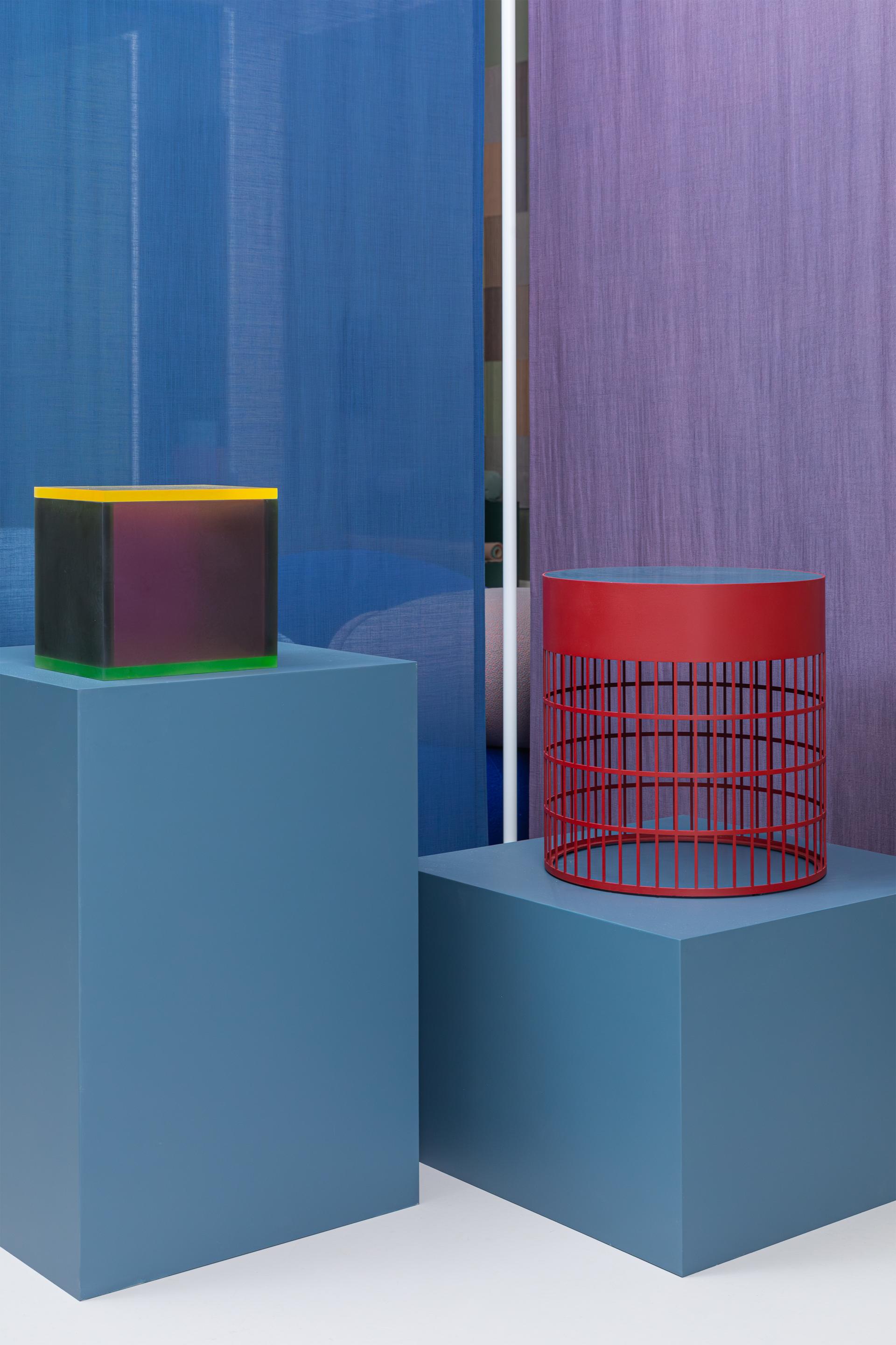 Colorful geometric forms against vibrant textile backdrops, showcasing Raw Color's innovative bio-based materials and design approach.