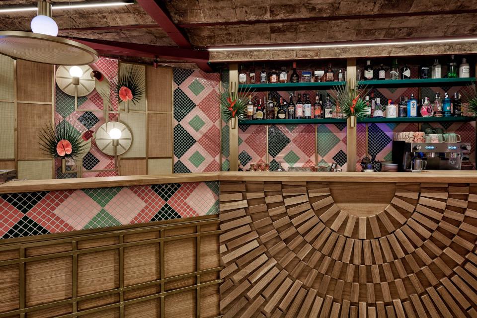 Vibrant interior of Kaikaya, featuring tropical decor and a stylish bar designed by Masquespacio in Valencia.