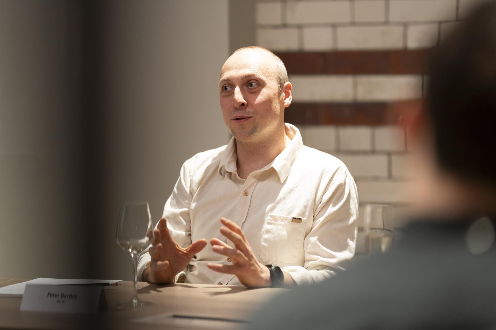 Discussion on technology's role in sustainable design with a participant engaged in conversation.