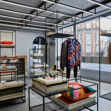 Luxurious interior of Browns store featuring vibrant clothing displays and modern lighting design by Nulty.