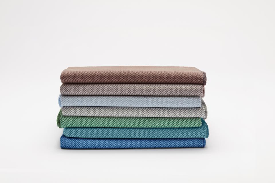Fabric samples in various colors showcasing Camira's sustainable textile innovation using recycled marine plastic.