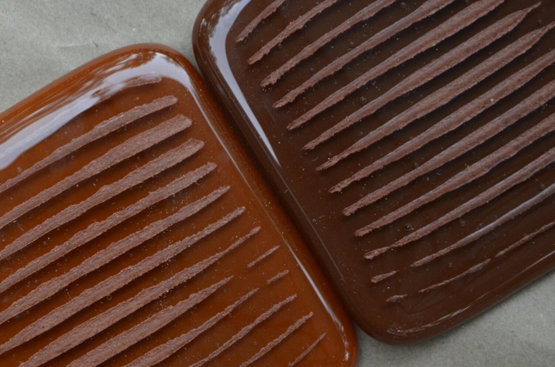 Two textured brown biomaterial samples showcasing innovative feedstock designs, highlighting sustainability in the biomaterials industry.