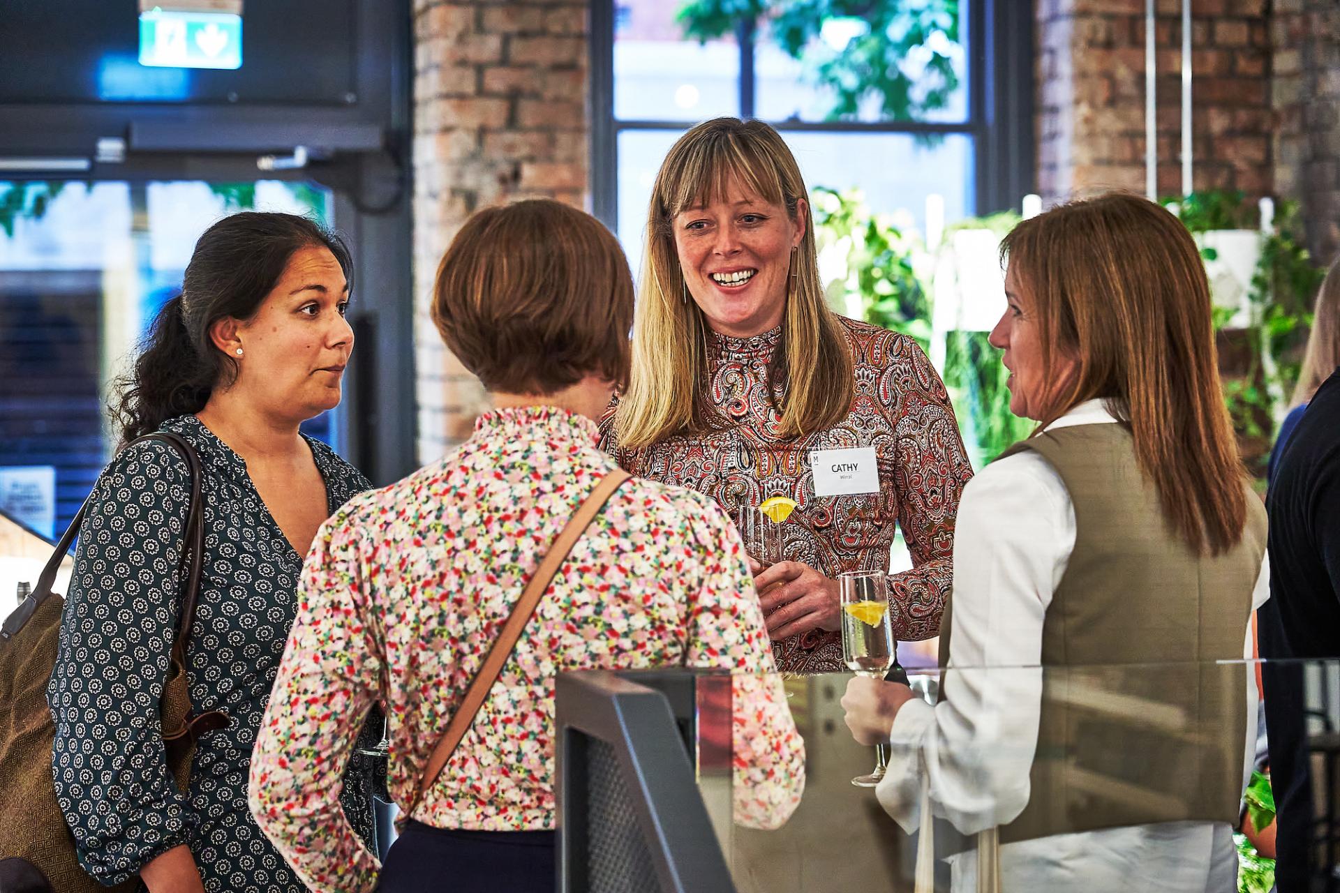 Attendees enjoying conversation and drinks during the celebration of the 42 Roles in the Built Environment podcast finale.