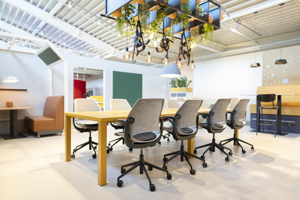 Stylish meeting room featuring Vepa's Be Hybrid task chairs with a sustainable design and ample natural lighting.