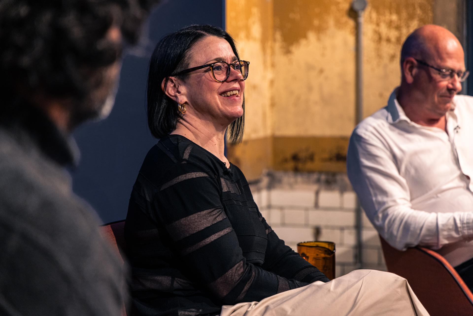 Panel discussion at Manchester property outlook seminar featuring a speaker engaged in conversation.