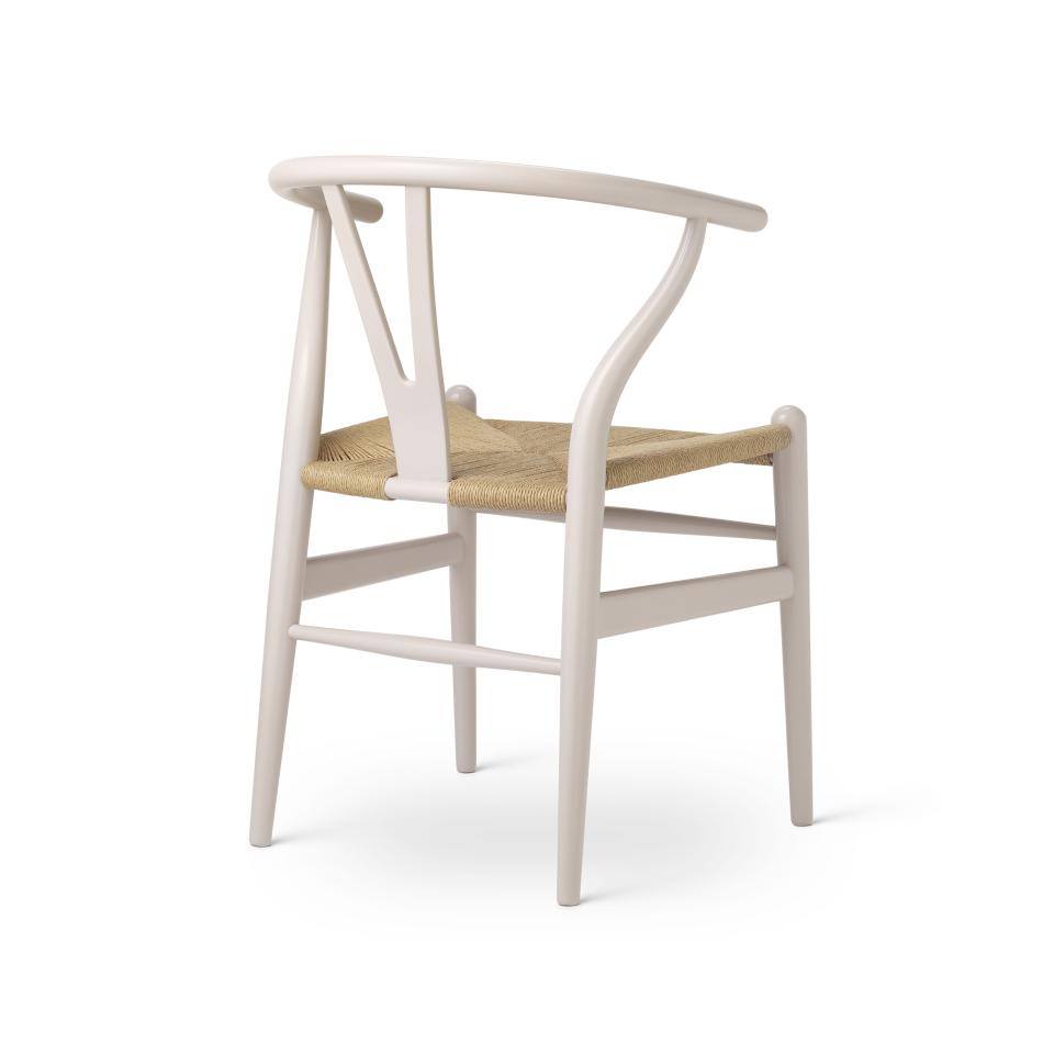 Wishbone chair by Carl Hansen & Son featuring a nature-inspired color palette and woven seat, symbolizing Danish design heritage.
