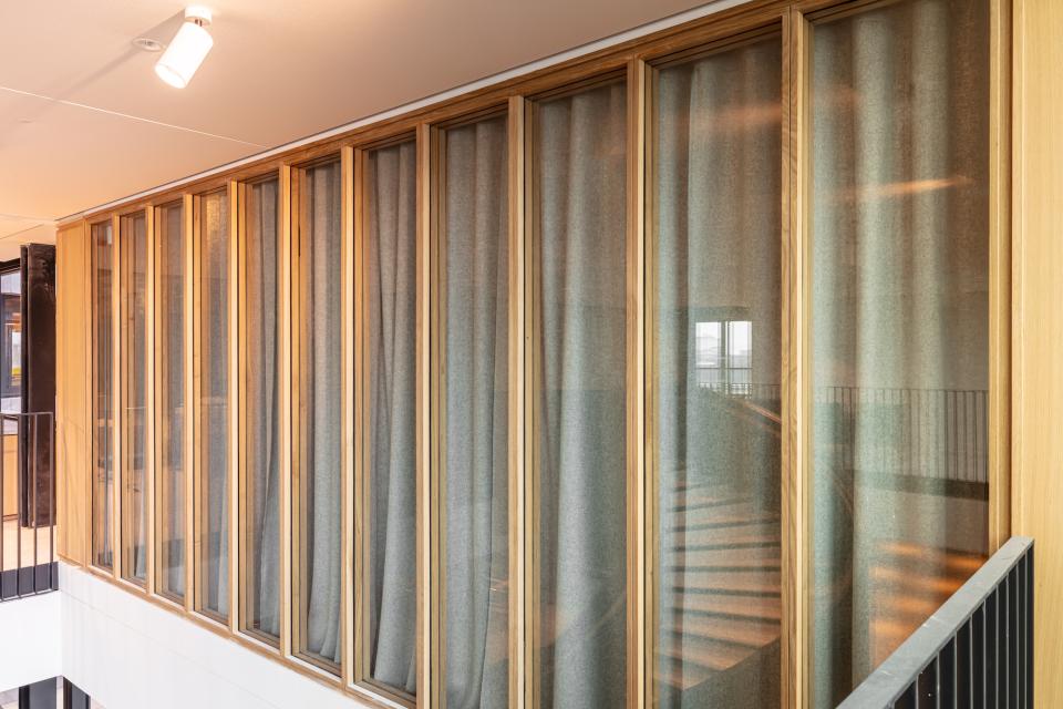 Bespoke timber-framed glazed partitioning featuring fabric drapes, designed for Boston Consulting Group's London office.