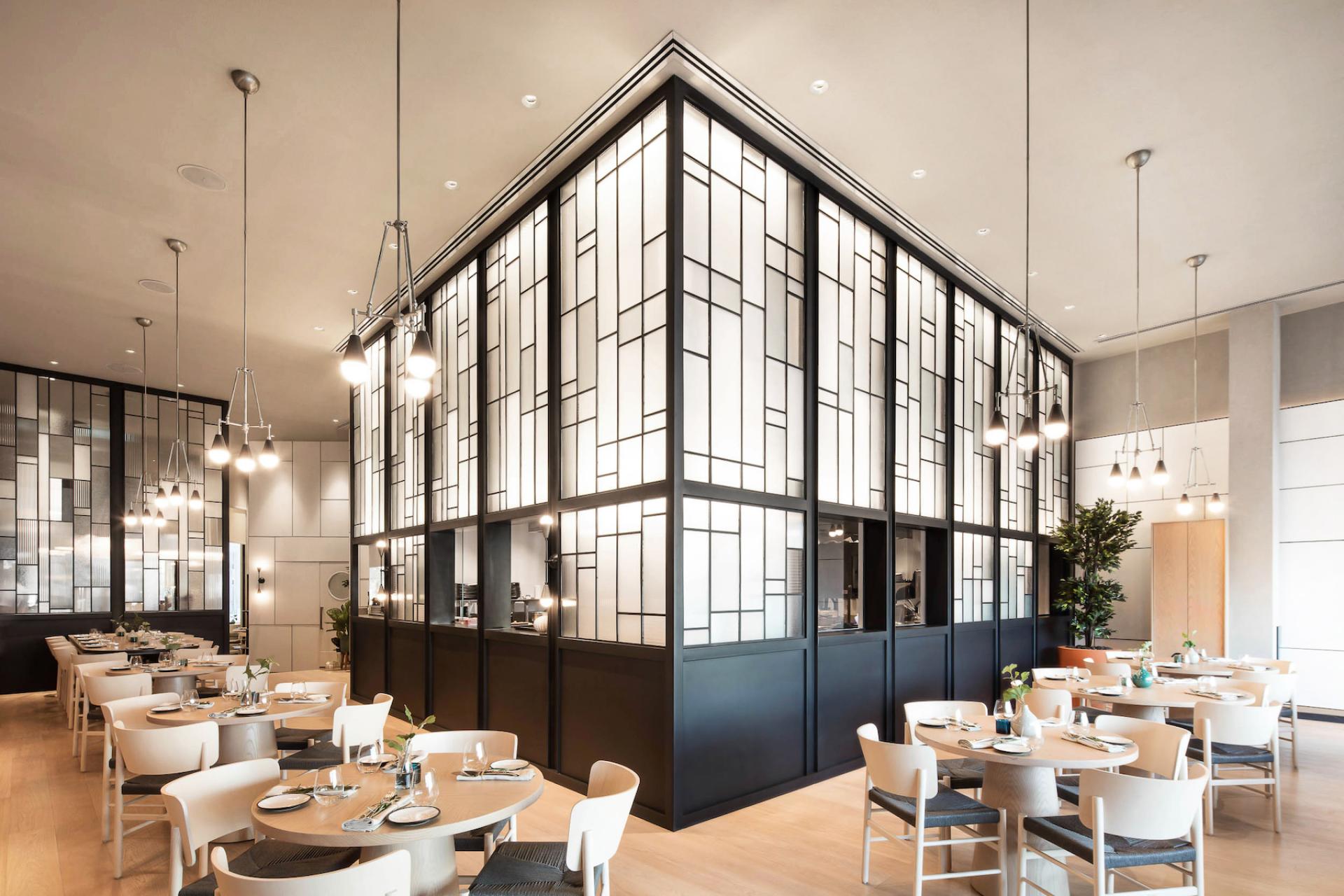 Modern café interior design featuring elegant lighting, minimalist decor, and a stylish dining setup in Dubai.