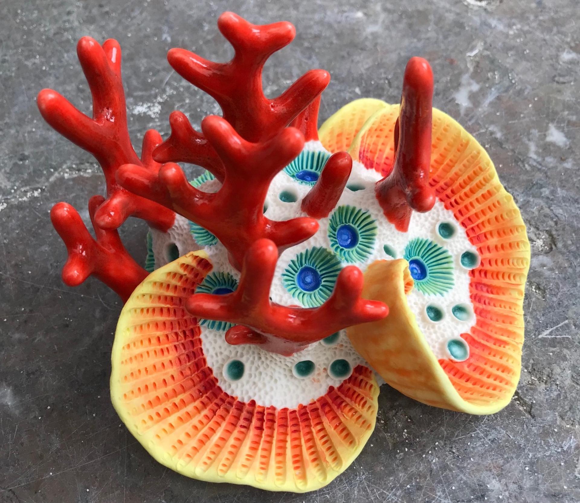 Colorful clay sculpture resembling coral, showcasing intricate details and vibrant colors in a marine-inspired design.