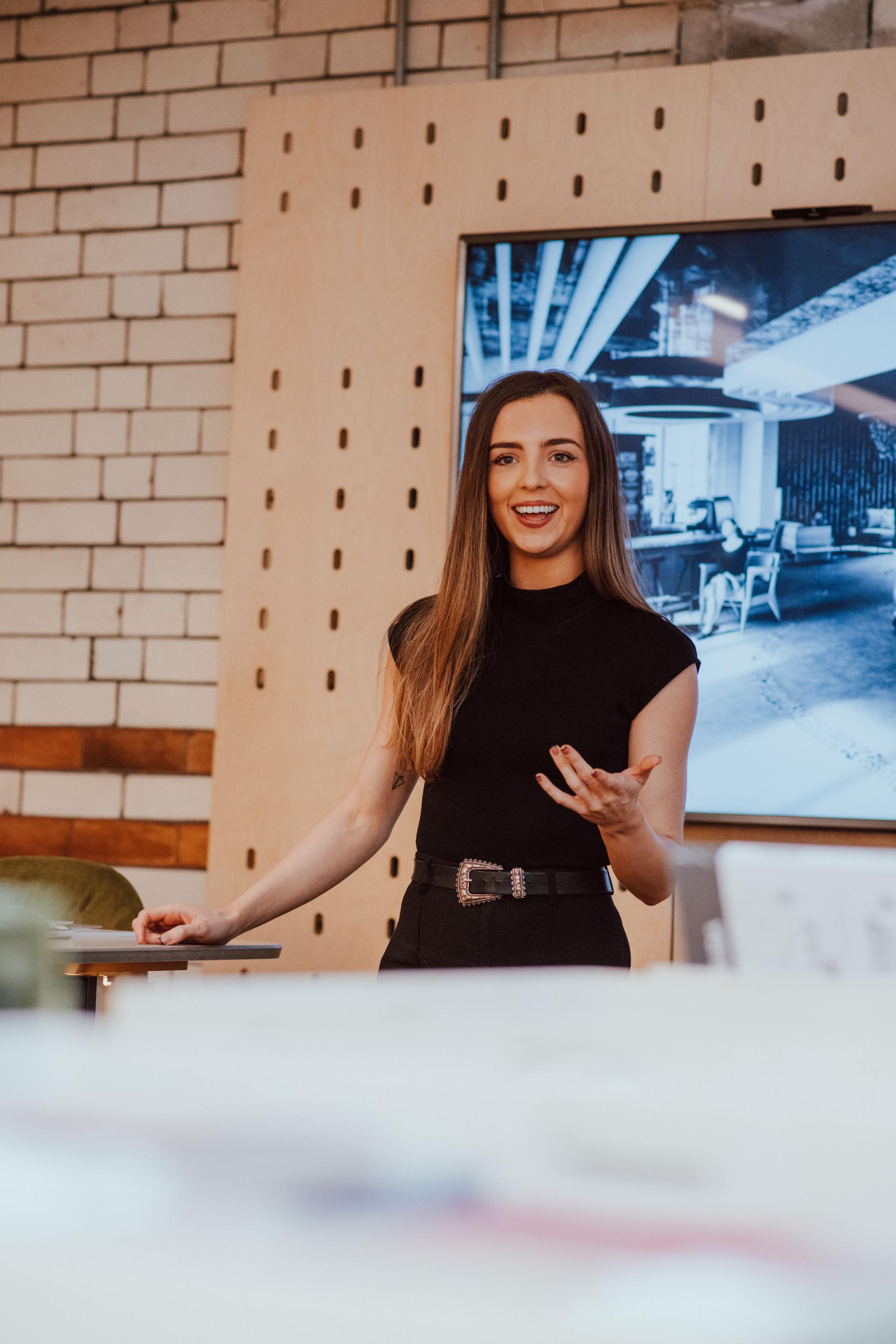 Engaged interior design student presenting innovative ideas during a collaborative session with Manchester Academy at SCENE Interiors.