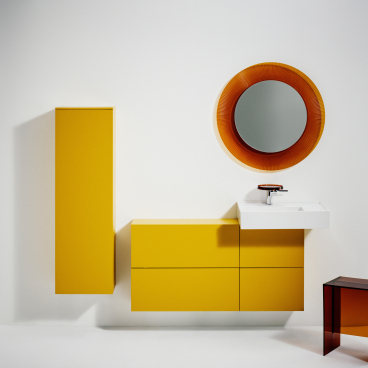 Stylish bathroom design featuring vibrant yellow cabinetry and a round mirror, blending Italian and Swiss aesthetics.
