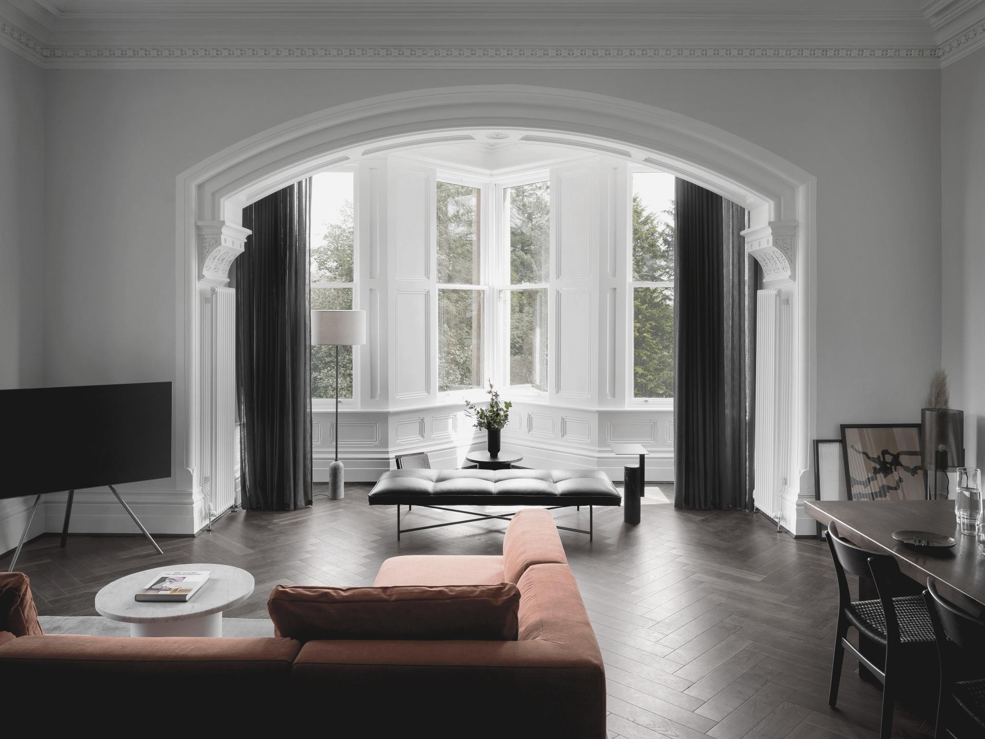 Stylish interior of a Manchester apartment featuring elegant furniture, large windows, and modern design elements.