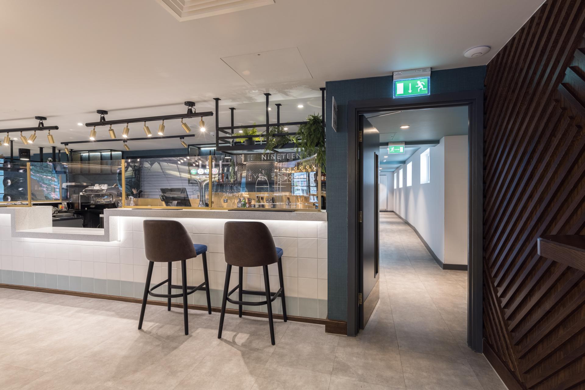 Modern bar interior of the Belgrade Theatre featuring stylish seating and ambient lighting, showcasing recent renovations.