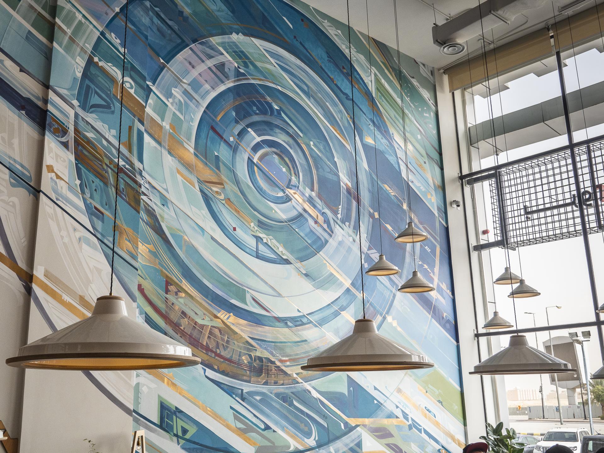 Vibrant mural featuring swirling blue and gold patterns in Brew92's interior design, highlighting Liqui Design's innovative approach.