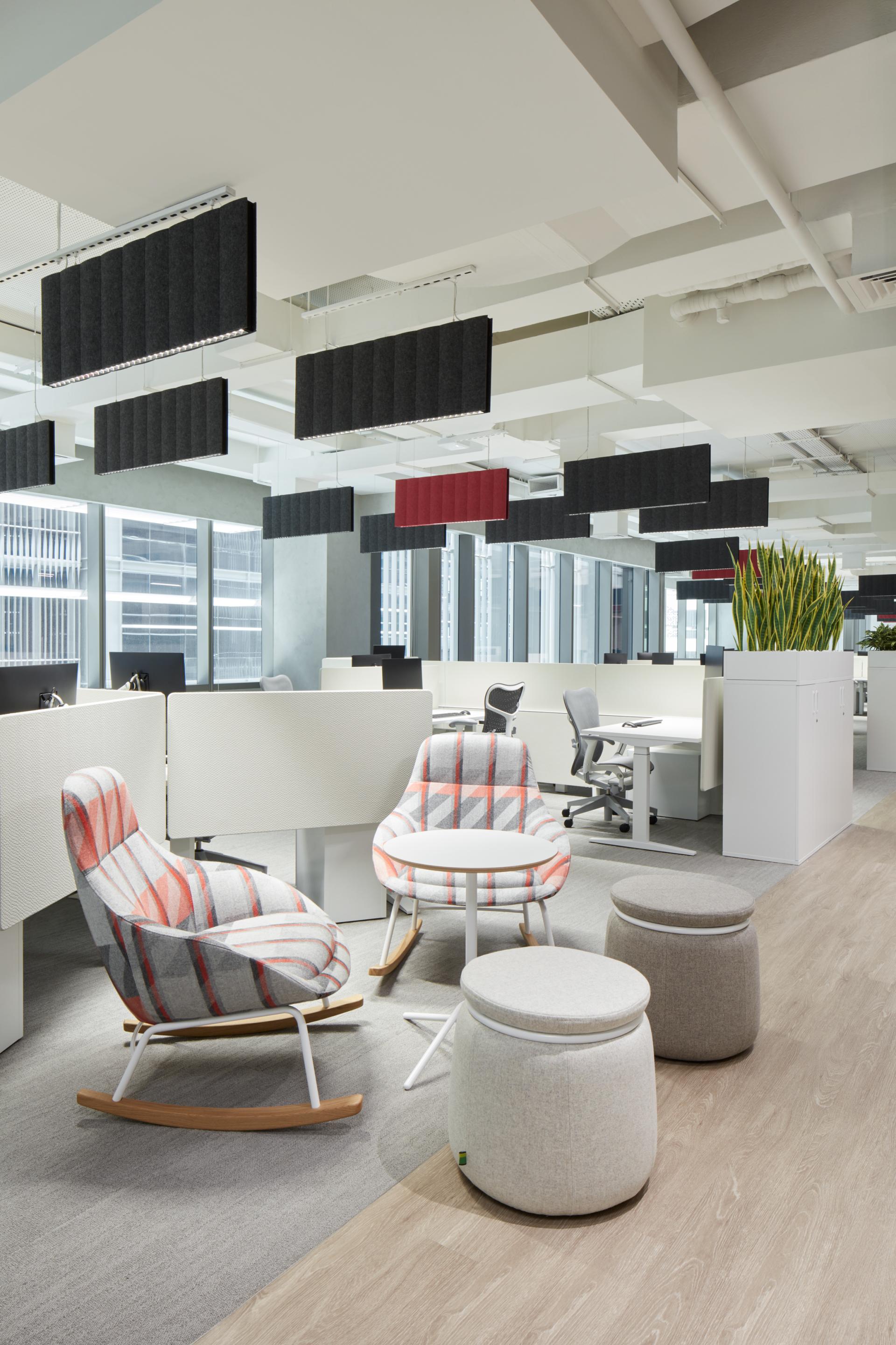 Modern office interior featuring vibrant seating, collaborative spaces, and sound-absorbing panels, reflecting innovative design in Dubai's new Takeda HQ.
