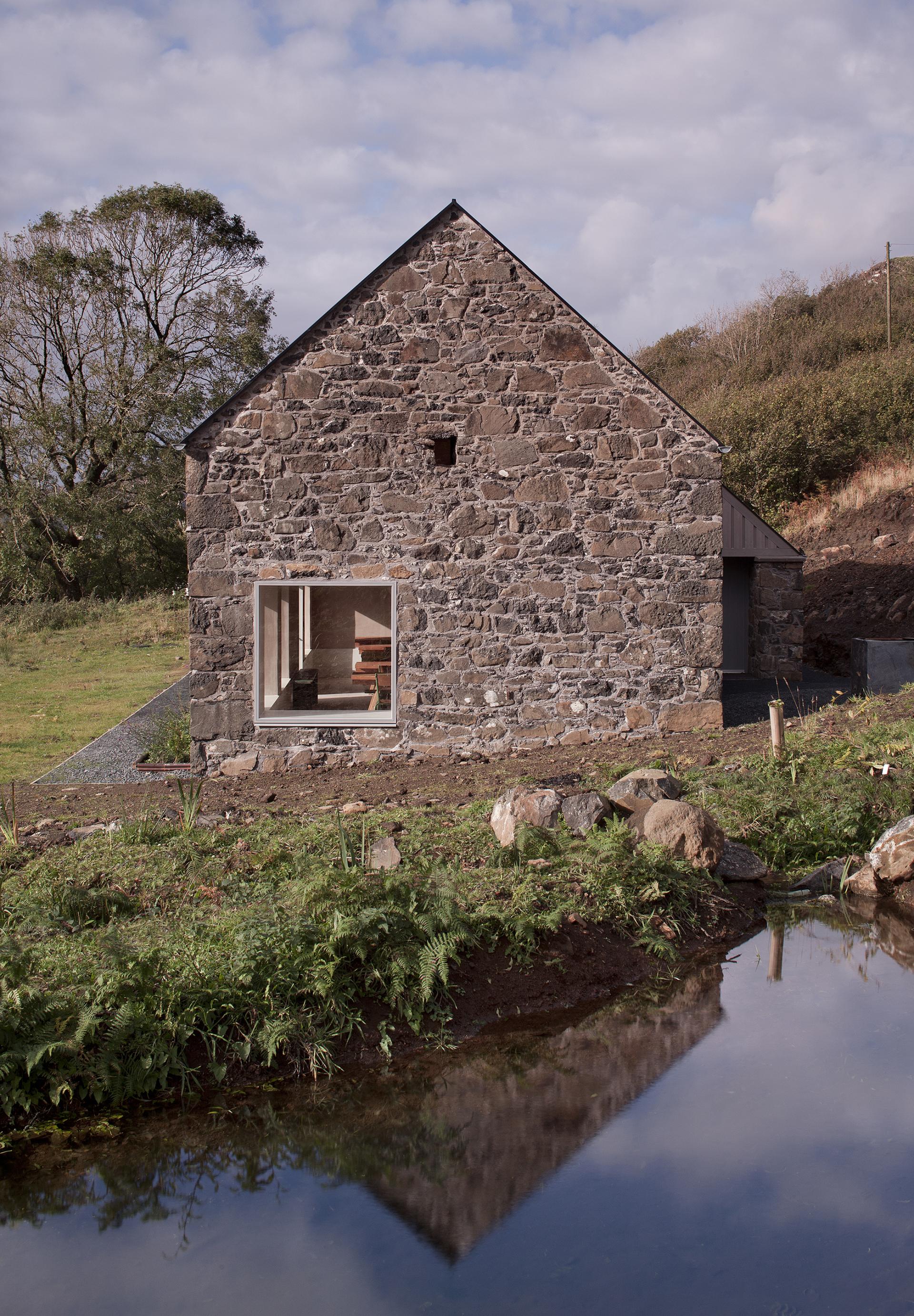 Restored croft on the Isle of Mull, featuring natural stone exterior and modern window, reflecting fardaa's sustainable design ethos.