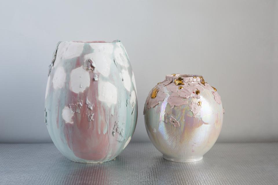 Two decorative vases by Coralla Maiuri showcasing iridescent effects, textured surfaces, and unique shapes, reflecting volcanic inspiration.
