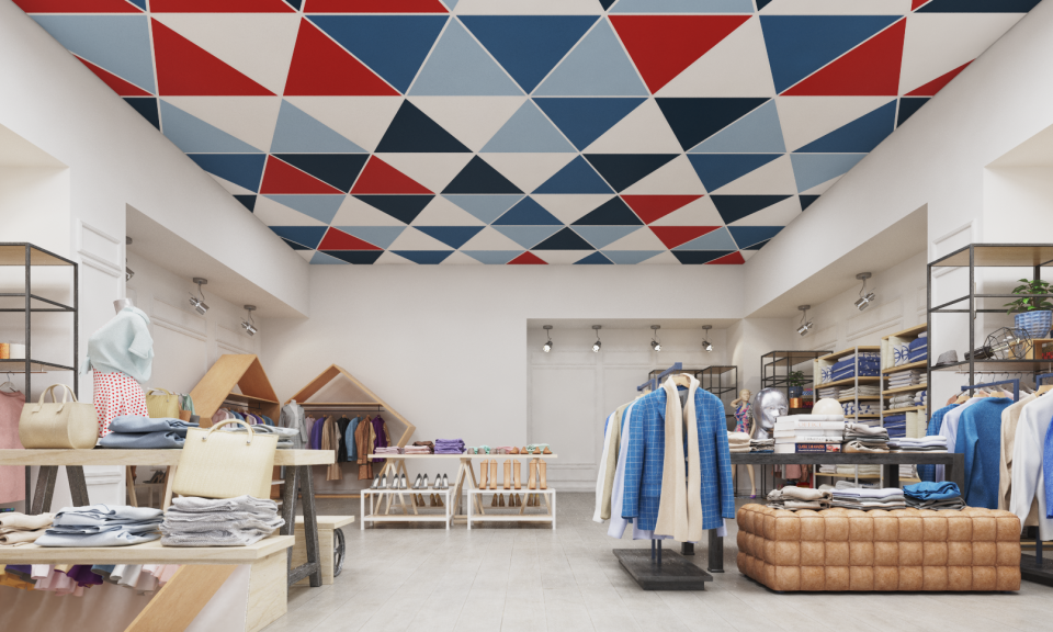 Colorful Aruba Triangle ceiling tiles by Zentia in a trendy boutique setting filled with clothing displays.
