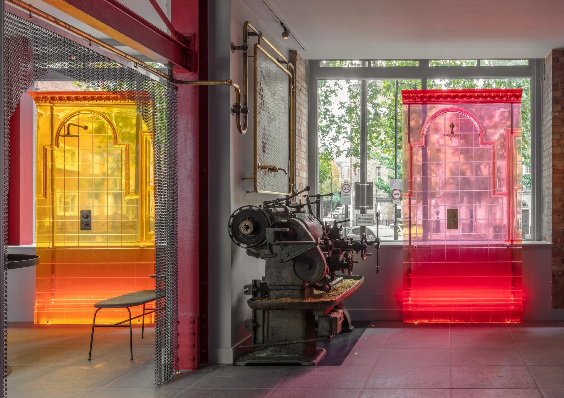 Brightly colored transparent structures contrast with vintage machinery in Holloway Li's innovative Clerkenwell showroom and co-working space.