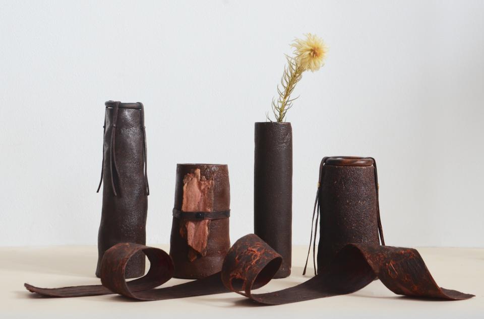 Unique biomaterial vases made from sustainable materials, showcasing innovative design and organic shapes with dried flowers.