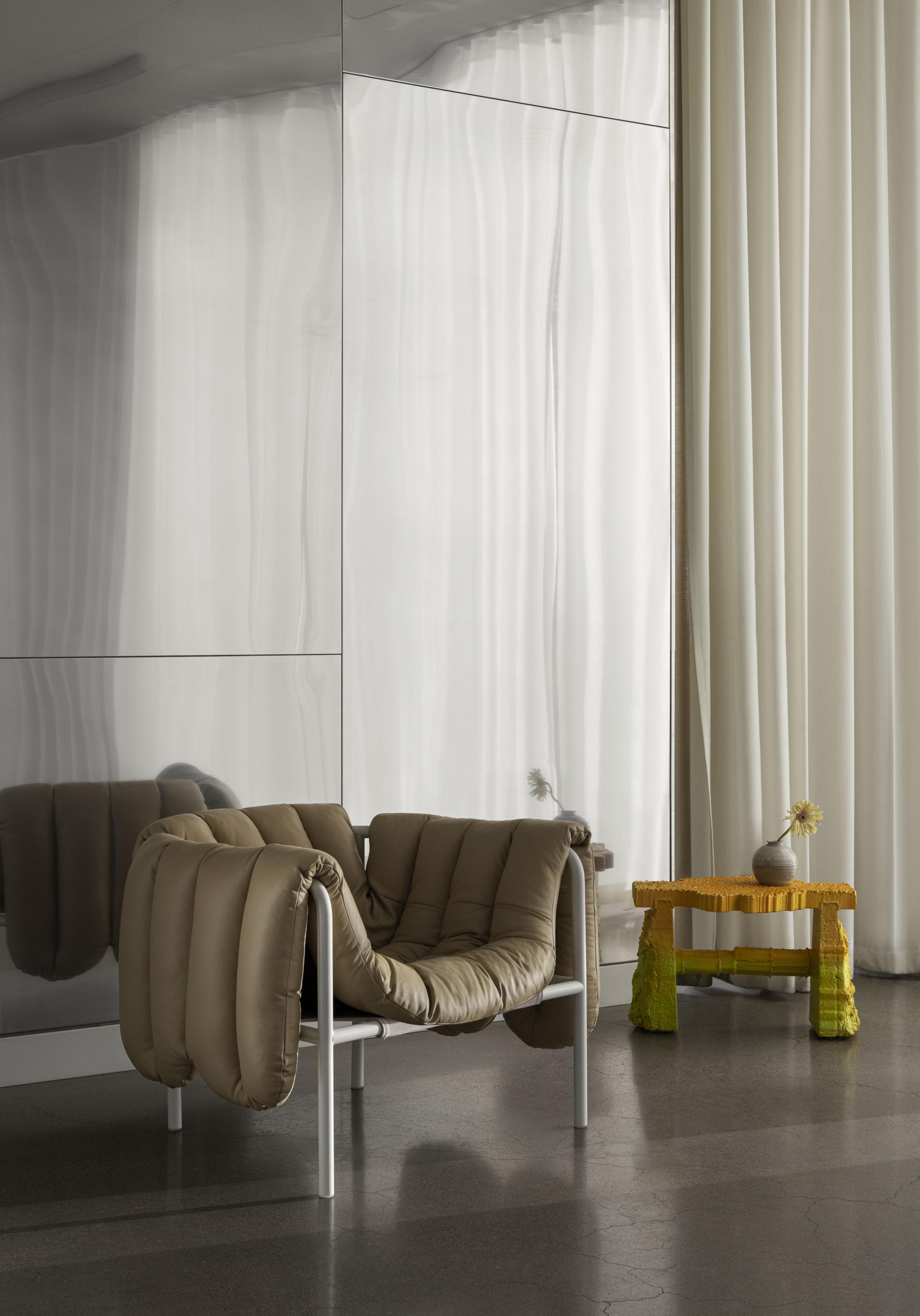 Puffy Lounge Chair by Toogood in a modern interior, showcasing soft, padded design and contemporary decor elements.