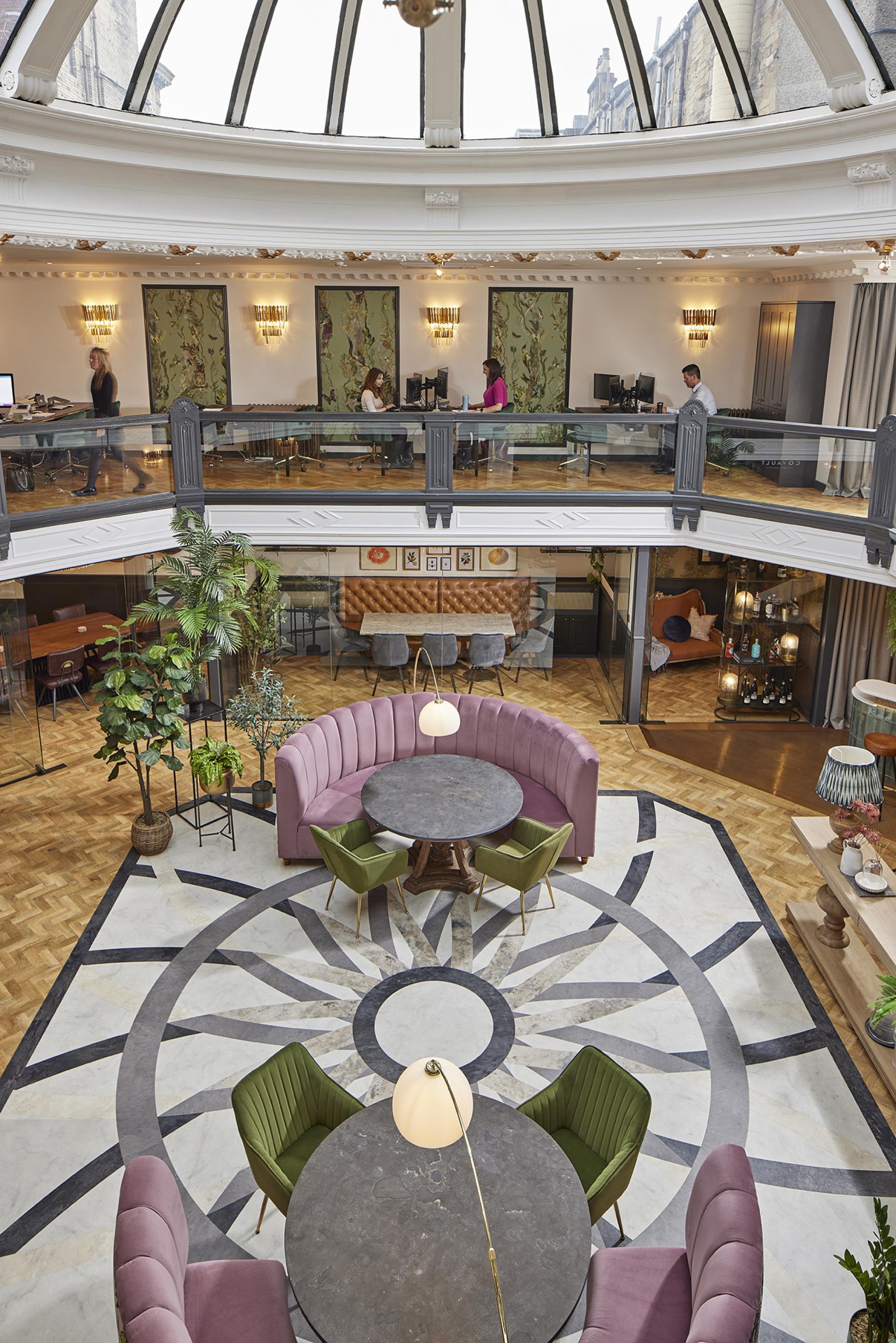 Stylish interior of CoVault Glasgow featuring Karndean Designflooring, showcasing modern seating and decorative elements.