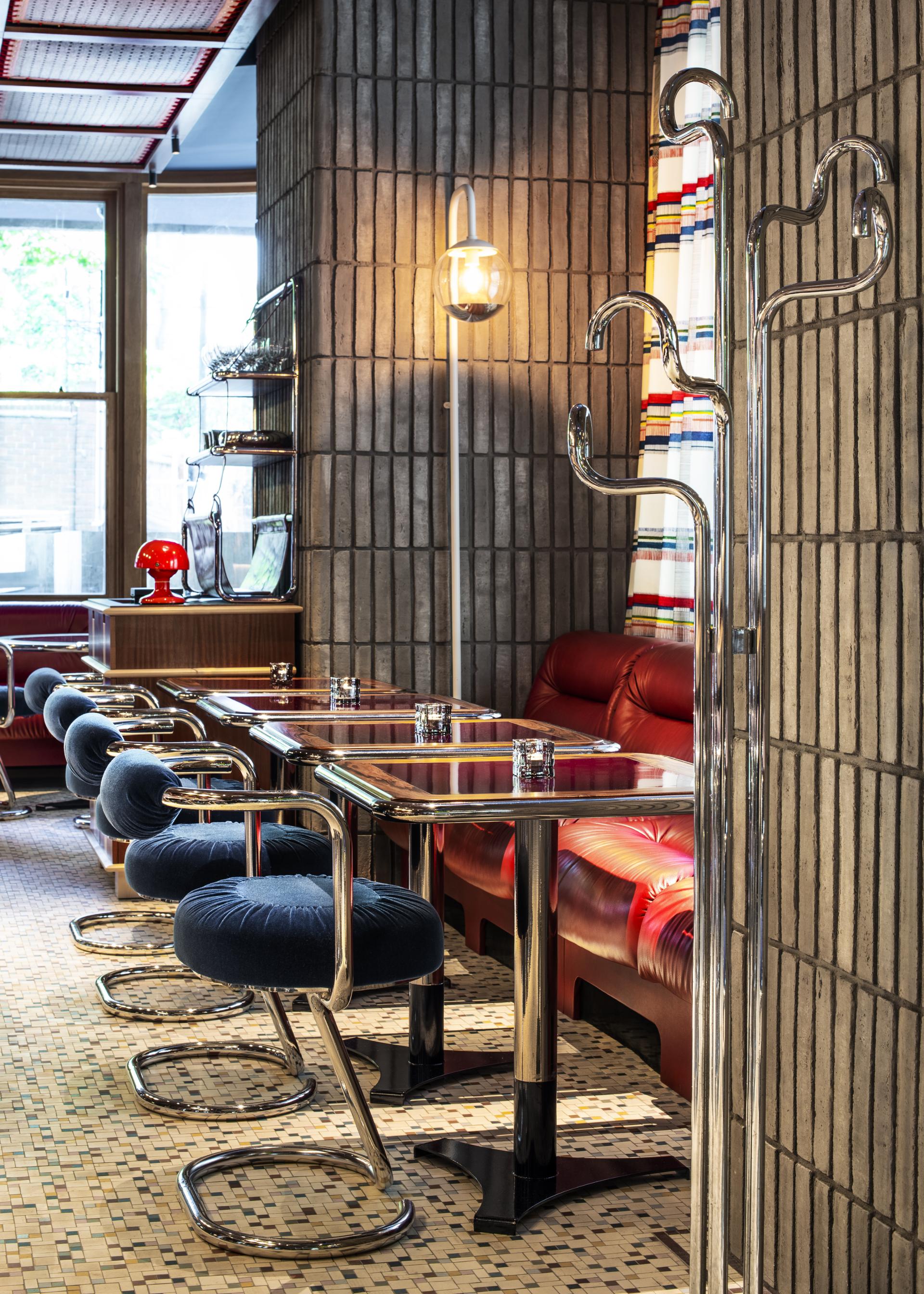 Stylish interior of The Standard, London, featuring cozy seating, contemporary tables, and unique lighting design.