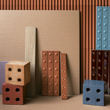 Colorful textured ceramic tiles and blocks arranged harmoniously, showcasing ten years of collaboration between Mutina and Studio Bouroullec.