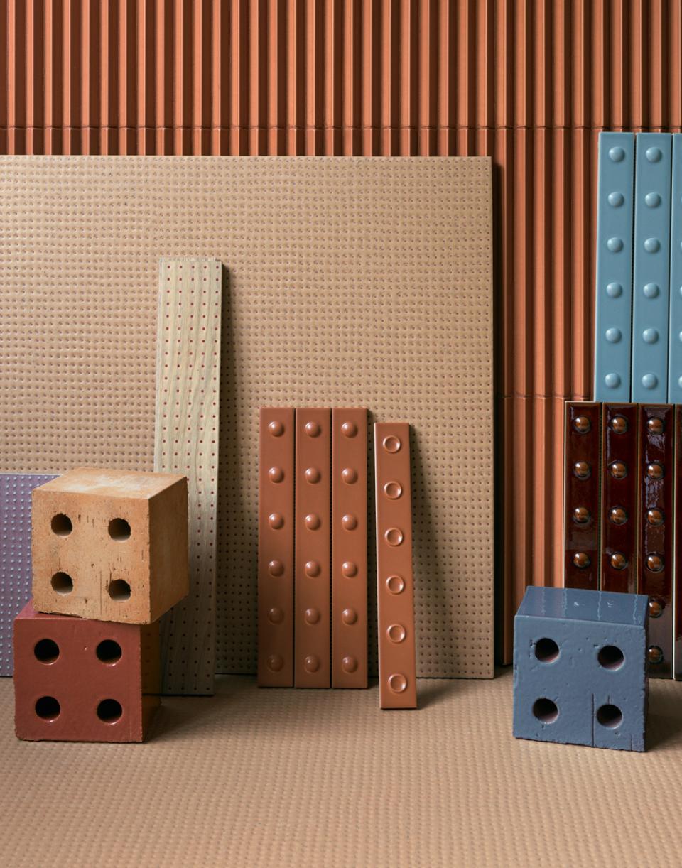 Colorful textured ceramic tiles and blocks arranged harmoniously, showcasing ten years of collaboration between Mutina and Studio Bouroullec.
