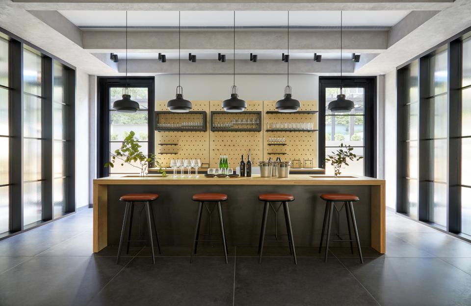 Stylish bar area featuring modern design, sleek stools, and elegant decor at PURO Kraków Kazimierz by Conran+Partners.