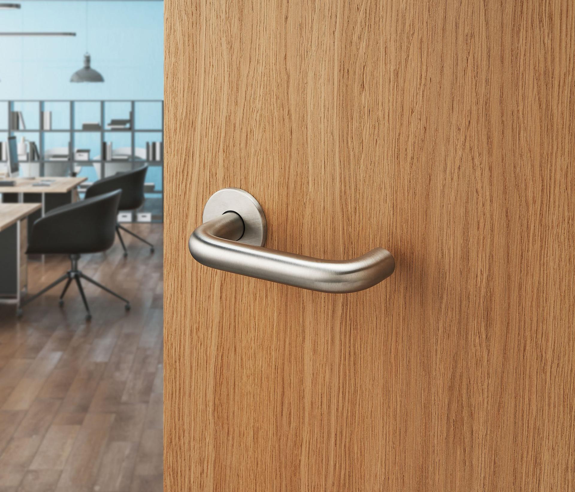 Contemporary door handle on an antimicrobial copper alloy door, highlighting Allgood's Contego collection for infection prevention.