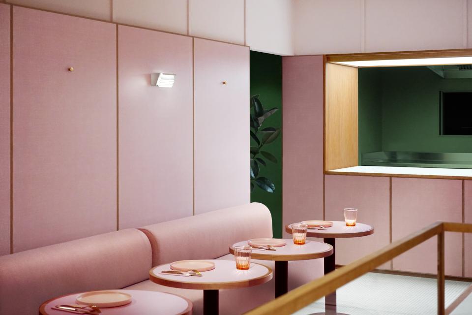 Nostalgic 1950s-style café interior featuring dusky-pink walls, circular tables, and elegant glassware.