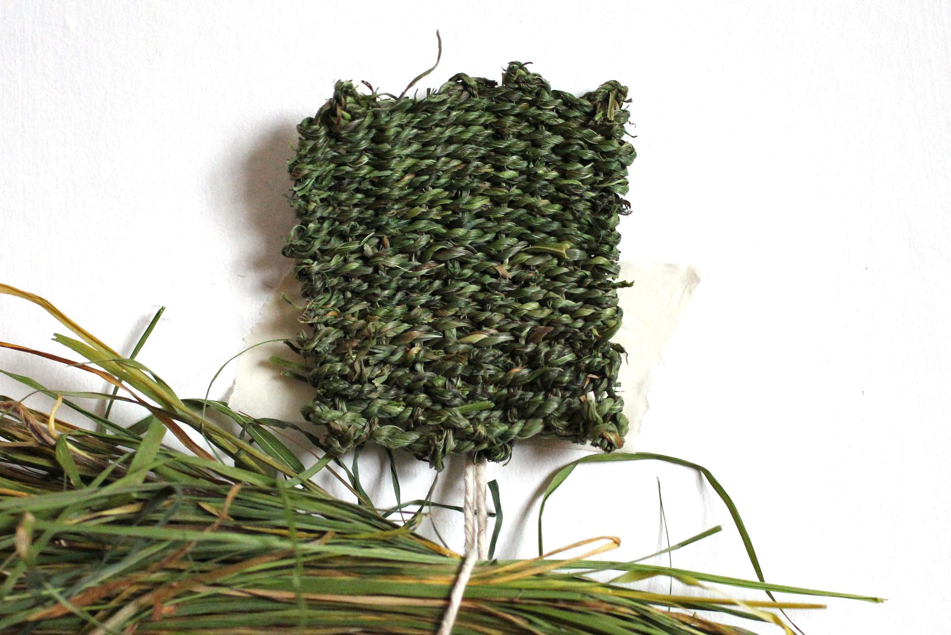 Woven grass material sample showcasing sustainable design in biomaterials by artist Hannah Elisabeth Jones.